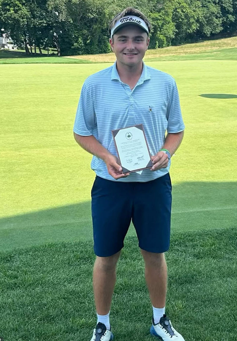 Joseph Dolezal holding a plaque