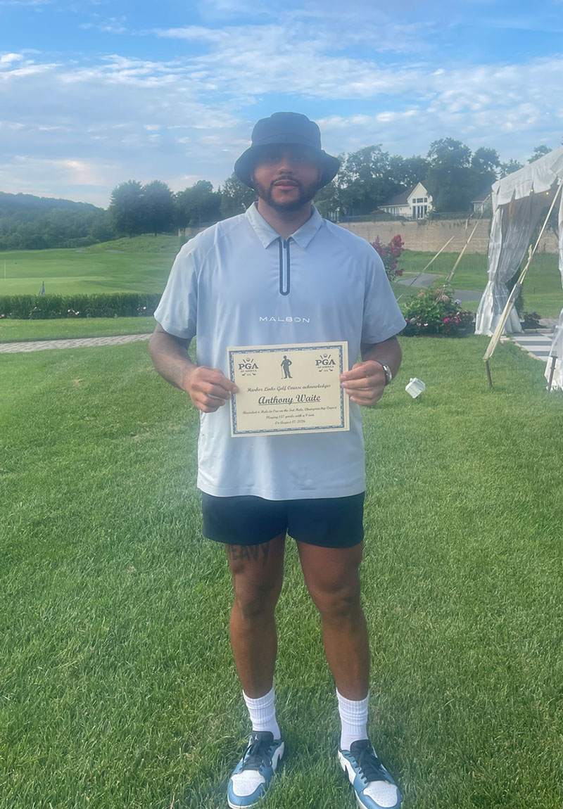 Anthony Waite holding his hole-in-one certificate