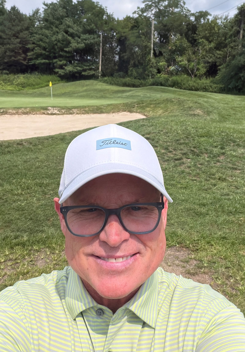 Matthew Norton smiling on the course