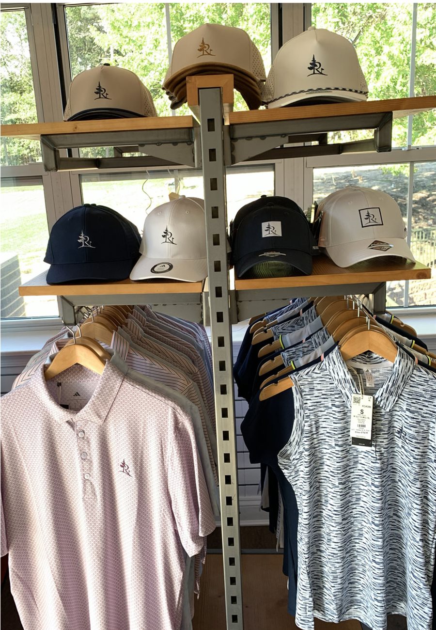 Pine Ridge branded polos and tops on a display rack