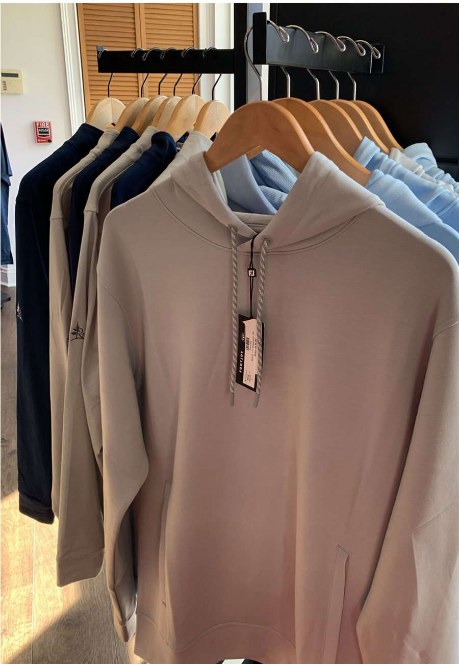 Pine Ridge branded hoodies hanging on a rack