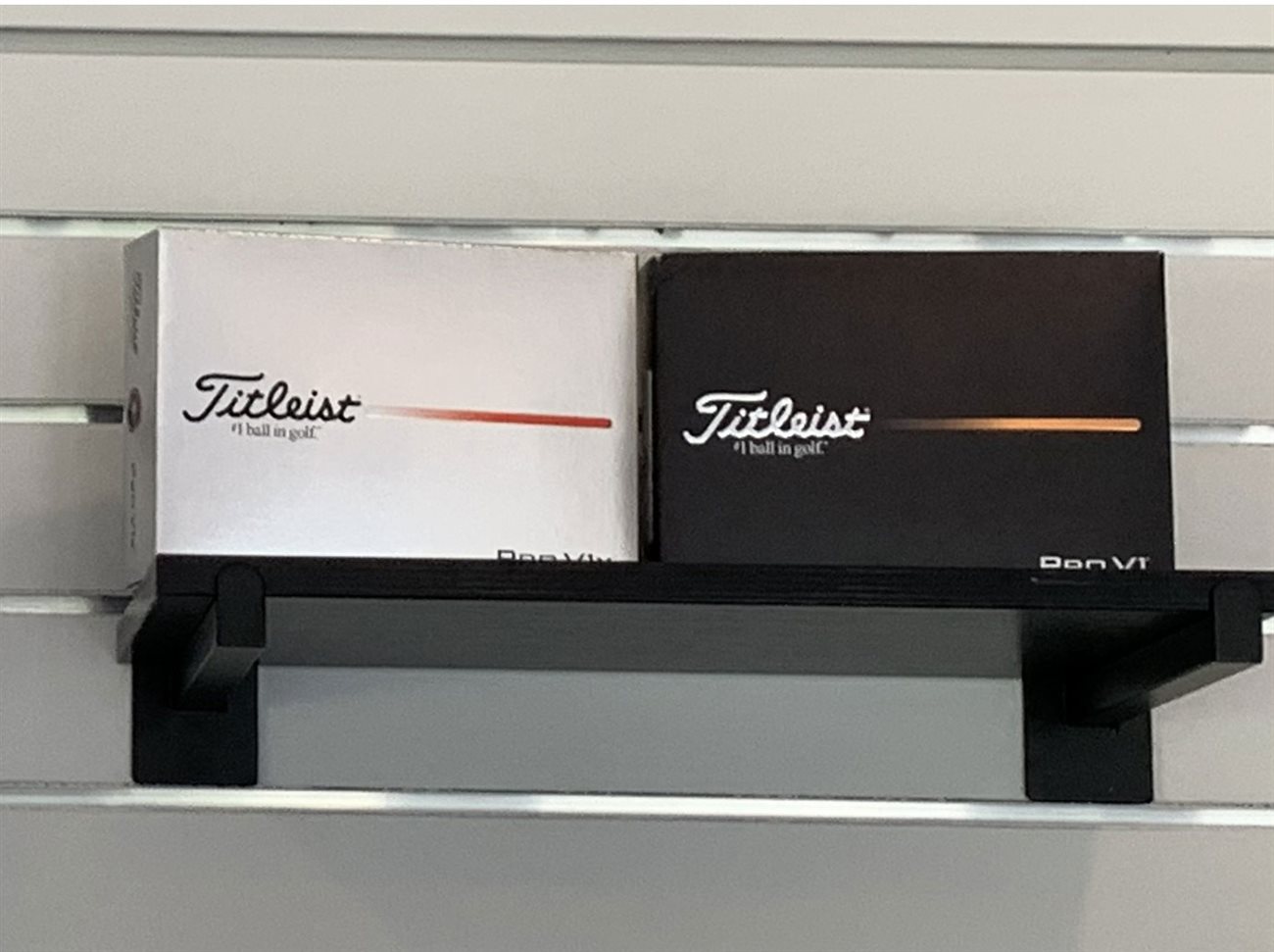 Titleist Pro V1 and Pro V1x golf ball boxes on a shelf