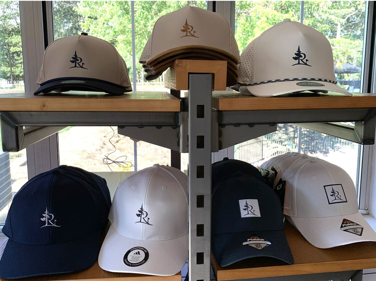 Pine Ridge branded caps in front of a window